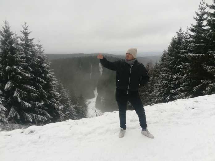 Mexican guy posing on a hill full of snow in Goslar Germany